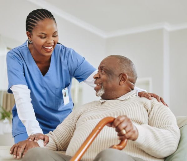 Caregiver-assisting-a-patient-get-up-from-seated-position